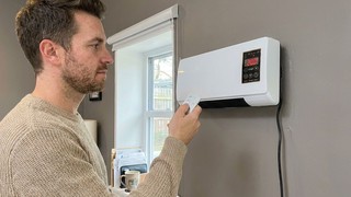 Adjusting the CoolCove on the bedroom wall